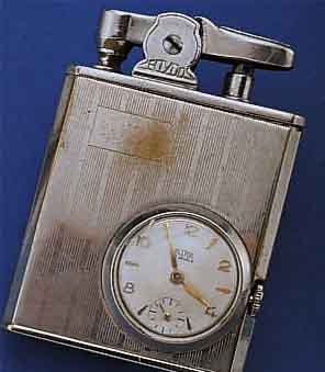 ECLYDO BENZINFEUERZEUG MIT EINGEBAUTER UHR, WOHL DTSCH. 50ER JAHRE, MESSING VERCHR., BER., TANKDICHTHEIT UNGEPR., 16 ST. STIFTEN- ANKERRUNDW., ...