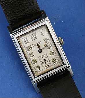 ZENTRA/TAVANNES HERRENARMBANDUHR, DEUTSCH- LAND/SCHWEIZ UM 1938, EDELST., RECT.-FORM, BODEN GEDR., IN SICH L. GEW., ORIG.-BLATT U. ZEIGER ...