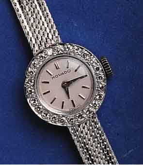 MOVADOMOVADO/CHOPARD DAMENGOLDBANDUHR, SCHWEIZ UM 1965, WG 750/000 RHOD., LÜNETTE AUFWEND. M. DIAMANTBES., BODEN GEDR., VERS. BLATT M. AUF- GES. ...