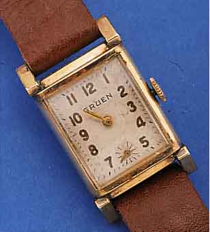 GRUEN HERRENARMBANDUHR, SCHWEIZ/USA UM 1950,METALL GG-AUFL., AUFWEND. RECT.-FORM, EDELST.-BODEN GEDR., BLATT FARBL. GET., FORMANKERW., 15 ST., KAL. ...