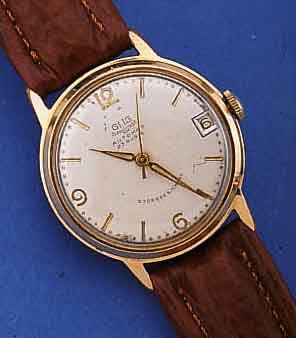 GUB HERRENARMBANDUHR AUTOMATIK, DEUTSCHLAND UM 1963, METALL ROTVERG., BER., EDELST.-BODEN GEDR., ORIG.-BLATT ALTERSBED. L. FL., DATUM WEIT AUßEN ...