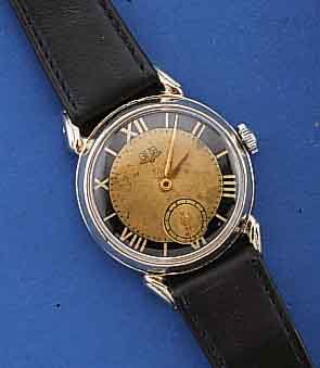 GUB HERRENARMBANDUHR, DEUTSCHLAND UM 1953, METALL NACHVERCHR., EDELST.-BODEN U. GLASR. GEDR., ORIG.-BLATT FL., KAL. 60, 15 ST., HANDAUFZUG, ...