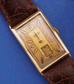 TISSOT HERRENARMBANDUHR, SCHWEIZ UM 1938, GG 585/000, SCHARNIERBODEN, RECT.-FORM, ORIG.- BLATT FARBL. GET., FORMANKERW., KAL. 20, 15 ST., GEPR. ...