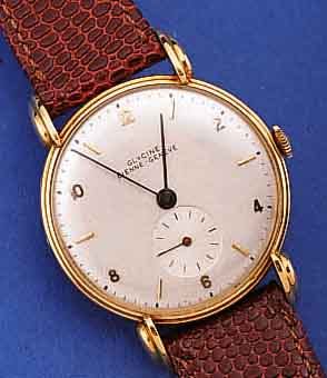 GLYCINE HERRENARMBANDUHR, SCHWEIZ UM 1948, FLACHES GG 750/000-GEH., BODEN GEDR., AUFWEND.AUFGES. U. GEST. BANDANST., BLATT REST., RUNDANKERW., ...