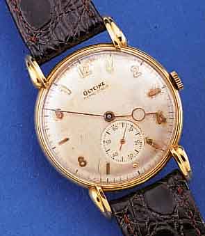 GLYCINE HERRENARMBANDUHR, SCHWEIZ UM 1948, FLACHES GG 750/000-GEH., BODEN GEDR., AUFWEND.AUFGES. U. GEST. BANDANST., ZIFFERBL. FL., RUNDANKERW., ...
