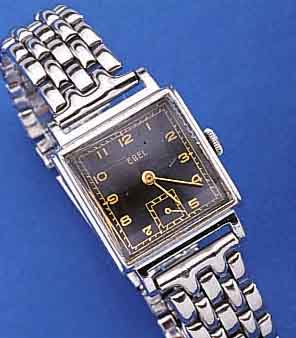 EBEL HERRENARMBANDUHR, SCHWEIZ UM 1945, METALL-CARREE-GEH. HARTVERCHR., EDELST.-BODEN GEDR., KONKAVGL., NEUTR. EDELST.-BAND, ORIG.- BLATT U. ...