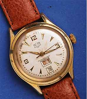 GUB HERGUB HERRENARMBANDUHR, KAL. 66,1, TAG U. DA- TUM BEI 6, DEUTSCHLAND UM 1959, METALL VERG., BER., EDELST.-BODEN GEDR., KORREKTURDR. SEITL. ...