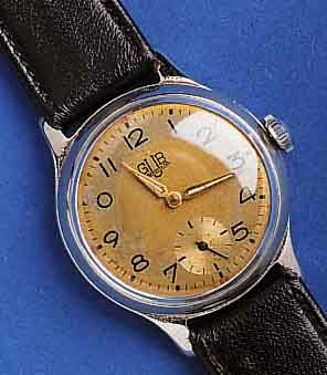 GUB HEGUB HERRENARMBANDUHR, KAL. 60, DEUTSCHLAND UM 1953, METALL NACHVERCHR., EDELST.-BODEN U. GLASR. GEDR., ORIG.-BLATT FL., 15 ST., HAND- ...