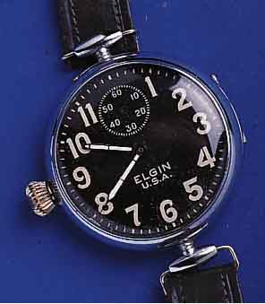 ELGIN FRÜELGIN FRÜHE FLIEGERUHR, USA UM 1917, METALL, SCHARNIERGEH. VERCHR., BEWEGL. BANDANST., ZUR BESSEREN ZEITABN. U. BED. KRONE AUßEN 9, KL. ...