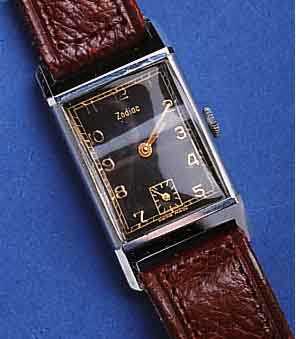 ZODIACZODIAC HERRENARMBANDUHR, SCHWEIZ UM 1938, METALL, RECT., HARTVERCHR., KONKAVGL., BODEN GEDR., LEDERB. ZEITIDENT., BLATT PERF. REST., ...