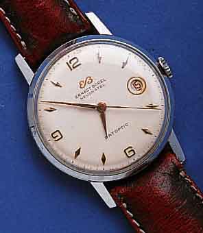 ERNESTERNEST BOREL HERRENARMBANDUHR DATOPTIC, SCHWEIZ UM 1955, METALL VERCHR., EDELST.- BODEN U. GLASR. GEDR., DATUM, ZENTRALSEK., 17 ST., ...