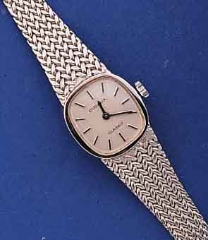 DUGENA DAMENGOLDBANDUHR, DEUTSCHLAND UM 1974, WG 585/000 INCL. WG-FEINGLIEDERBAND, BODEN GEDR., UNGETR. LAGERW., FORMANKERW. M. STAUBKONTAINER, 17 ...