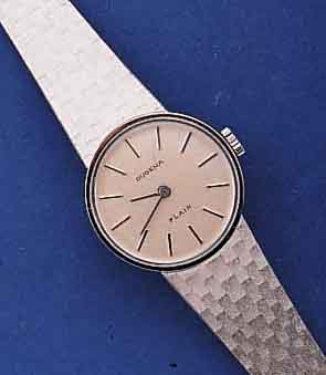 DUGENA DAMENGOLDBANDUHR MODELL FLAIR, UNGE- TR. LAGERW., SCHWEIZ UM 1970, WG 585/000 INCL. WG-BAND, BODEN GEDR., FORMANKERW. VERG., 17 ST., ...