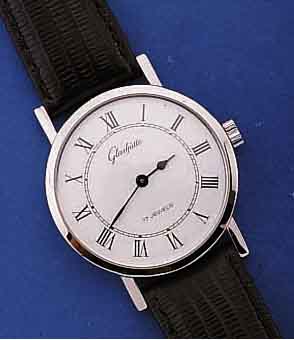 GLASHÜTTE HERRENARMBANDUHR, DEUTSCHLAND UM 1982, METALL HARTVERCHR., BODEN GEDR., EMAIL- FARB. KONTRASTZIFFERBL., DAMENFORMANKERW., GUB KAL. ...