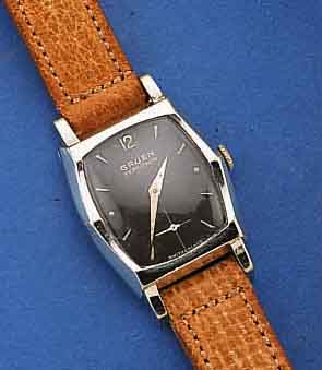 GRUEN HERRENARMBANDUHR VERY THIN, METALL, WG-AUFL., EDELST.-BOD. AUFGEDR., SCHWARZES KONTRASTZIFFERBL., SCHWEIZ/USA UM 1955, 17 ST. , HANDAUFZUG, ...