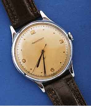 JAEGER LE COULTRE HERRENARMBANDUHR, SCHWEIZ UM 1948, EDELST., BOD. U. GLASRD. AUFGEDR., ORIG. BL. U. ZEIGER, LEDERBD. NEU, WERK VERN., 15 ST., ...