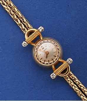 OMEGA DAMENSCHMUCKBANDUHR, SCHWEIZ UM 1958, GG 750/000, 2-REIHIGES KÖNIGSGLIEDERBD., AN D. BANDANST. HERVORGEH. IN WG-GEFASSTE DIAMANTEN , ...
