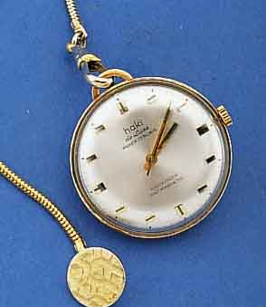 HAKI FRACK-/ANHÄNGEUHR, DEUTSCHLAND UM 1968, GG 585/000, EINSCHALENGEH., VERSILB. BL., 17 ST., HANDAUFZUG, KAL. LORSA, STOßGES., D. CA. 33 MM, ...