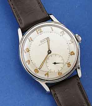 TISSOT HERRENARMBANDUHR, HAMMERAUTOMATIK, EDELST., BOD. GESCHR., SCHWEIZ UM 1950, 2-FAR- BIG VERSILB. BL., ALTERSBED. LT. FLECKIG, AUS- SER LEDERBD. ...