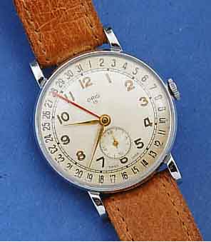 ORIS FRÜHE HERRENARMBANDUHR M. DAT. A. ZIFFER- BL. AUßENKRANZ, METALL VERCHR., EDELST.-BOD. U. GLASRAND AUFGEDR., SCHWEIZ UM 1952, D. CA. 35 MM, ...