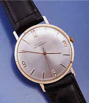 DOXA HERRENGOLDUHR, SCHWEIZ UM 1960, ROSE-G. 585/000, GLASR. GEDR., FLACHE AUSF., LEDERB. NEU, VERS. BLATT, ANTIMAGNETIK, RUNDANKERW., KAL. 103, ...