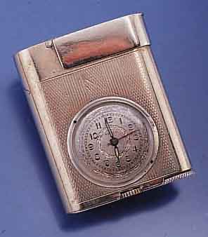 ETERNA WATCH CO/WEISCO BENZINFEUERZEUG MIT INTEGRIERTER UHR, SCHWEIZ UM 1950, METALL VERS., 17 ST. ANKERW., INCABL. STOßGES., ÜBERH. UNERL., ...