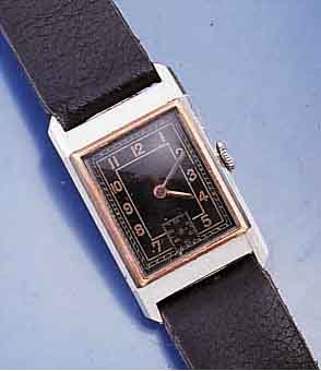 RECORD HERRENARMBANDUHR, SCHWEIZ UM 1937, EDELST.,RECT.-FORM, RG-LÜNETTE, MAßE CA. 38 X 22 MM, LEDERB. NEU, ORIG.-BLATT FL., BODEN GEDR., IN ...