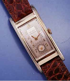 GRUEN CURVEX HERRENARMBANDUHR SERIE PRECISION, GG-FILLED, GEZOGENE RECT.-FORM IN SICH GE- W., MAßE CA. 45 X 20 MM, 2-FARB. VERS. BLATT, KL. SEK. ...