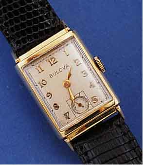 BULOVA HERRENGOLDUHR, SCHWEIZ/USA UM 1949, GG 585/000, RECT., KONKAVGL., BODEN GEDR., VERS. BLATT ALTERSBED. L. FL., 21 ST., FORM- ANKERW., KAL. ...