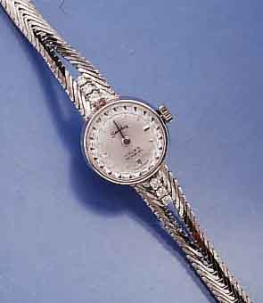 SANDOZ DAMENSCHMUCKBANDUHR, SCHWEIZ UM 1968, WG 750/000 INCL. 2-REIH. WG-GLIEDERB., RHOD., BANDANST. M. 6 DIAMANTEN BEL., BODEN GEDR., FORMANKERW., ...