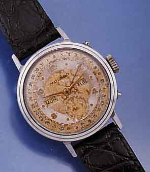 MOVADO HERRENARMBANDUHR M. VOLLKALENDERANZ., AUßER MONDPHASE, EDELST.-BOD. GESCHR., SCHWEIZ UM 1949, 2-FARB. VERS. BL., ALTERSBED. FLECKIG, ...
