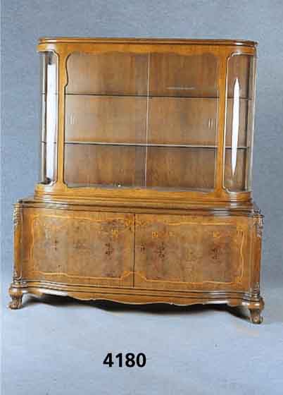 Vitrinenschrank, deutsch, um 1928/30, z.T. Nußbaum massiv, Kaukasisch Nußbaumfurnier, ge- spiegelt, qualitÄtvolle Intarsien in Birke, ...