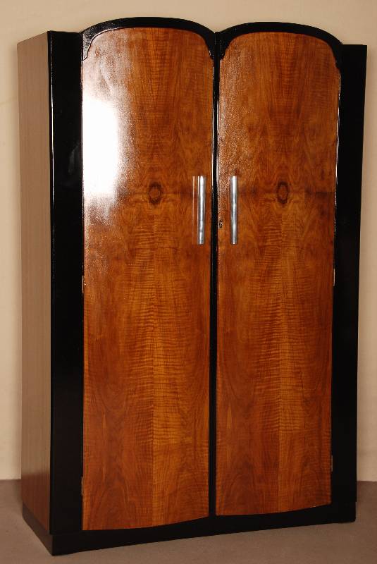 ArtDeco-Schrank, USA, um 1920, zweitÜrig, in ausdrucksstarkem Nußbaum, zum Teil schwarz abgesetzt, TÜren in zeittypisch eleganter Form nach ...