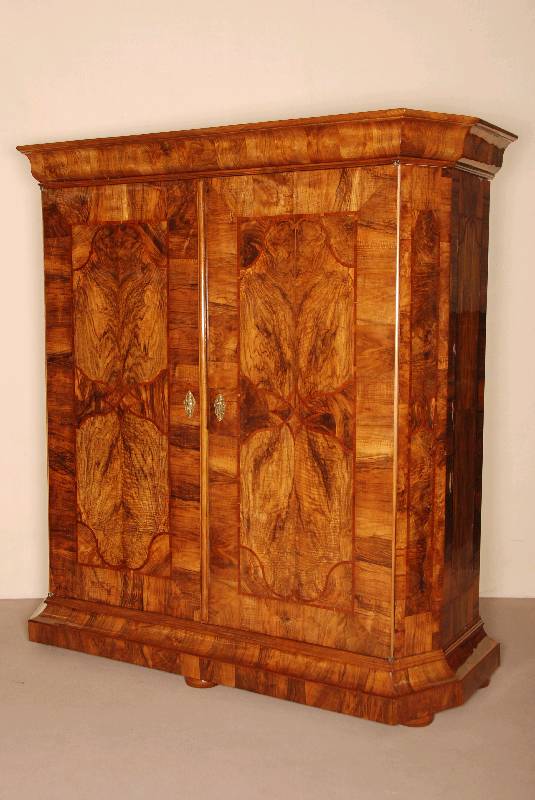 Barockschrank, sÜddeutsch, um 1750, Korpus Weichholz, Wurzelnuß furniert, doppelt bzw. 4 -fach gespiegelt verlegt, Kopf 5-fach getreppt und ...