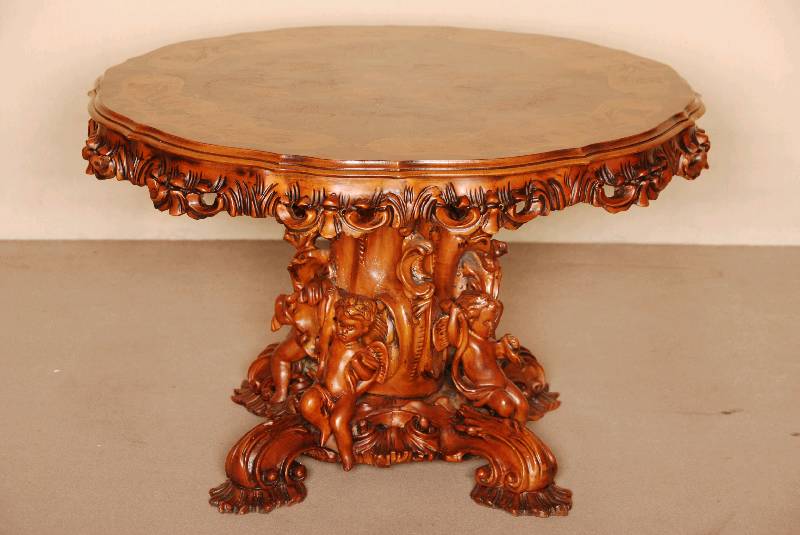 Couchtisch, italienischer Barockstil, um 1960 , schweres Fußteil mit aufwendigen Schnitzereien, 4 Putten aus dem Vollholz geschnitzt, Zarge mit ...