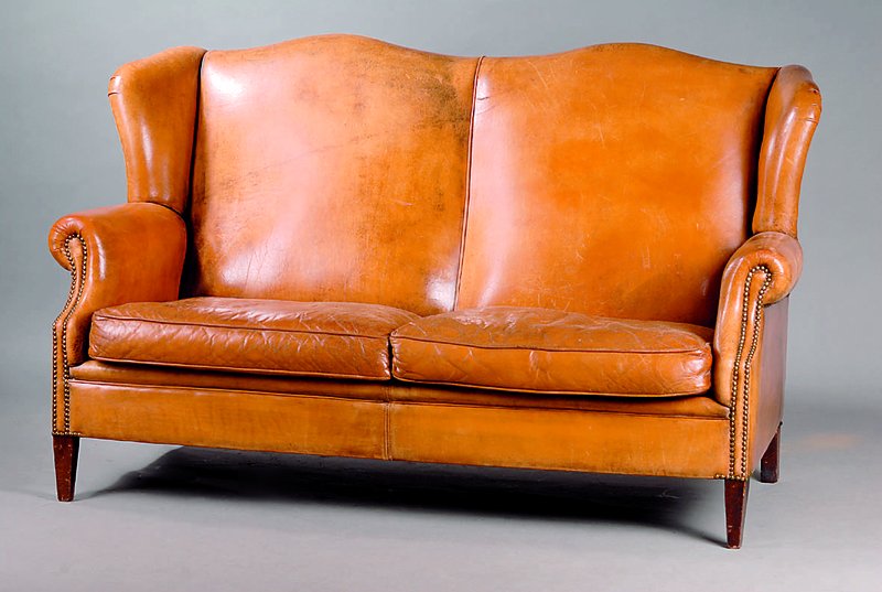 Ledersofa, wohl deutsch, 50er Jahre, Ohrenform, seitlich in Ohrenform auslaufend, Leder mit Patina, Gebrauchsschäden, 98 x 155 x 82 cm, Sh. 47 cm, ...