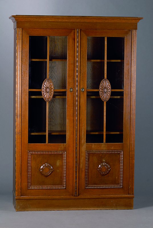 Bücherschrank, wohl Karlsruhe, um 1910, Eiche, reiner Jugendstil, teils facett. verglast, 2-türig, versprosst, ausgesetzte Schnitzereien, 4 ...