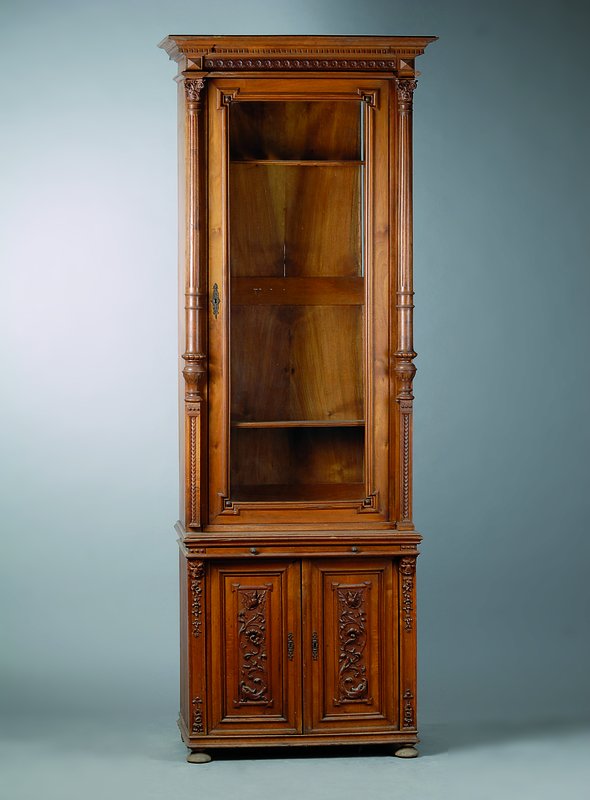 Waffenschrank, deutsch, um 1880-90, Nußbaum mit Wurzelnußfurnieren, Oberteil 1-türig verglast, Lisenen mit 3/4 Säulen, reich geschnitzt, ...