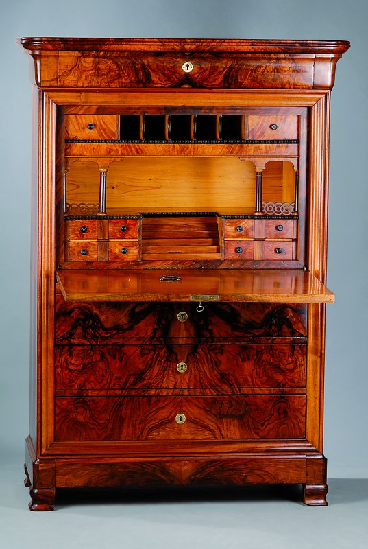 Standsekretär, um 1830, lebendiges Wurzelnußfurnier, vielfach gespiegelt verlegt, 3 -schübig, Klappe mit reicher Inneneinrichtung und 2 ...