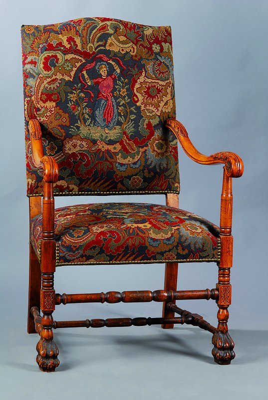 Armlehnstuhl, um 1890, Buche/Nußbaum, reich geschnitzt, Armlehnen in Voluten auslaufend, Nagelverzierung, st. Gebr.-Sp., ca. 112x67x67 cm, Sh. 46 cm