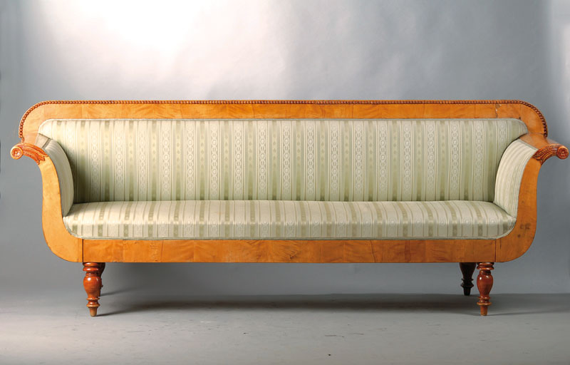 Biedermeiersofa, um 1835/40, Birke furniert, Rücken mit Perlleistenverzierung, Armlehnen in stilüblichem Füllhorndekor, Balusterfüße sek., Bezug ...
