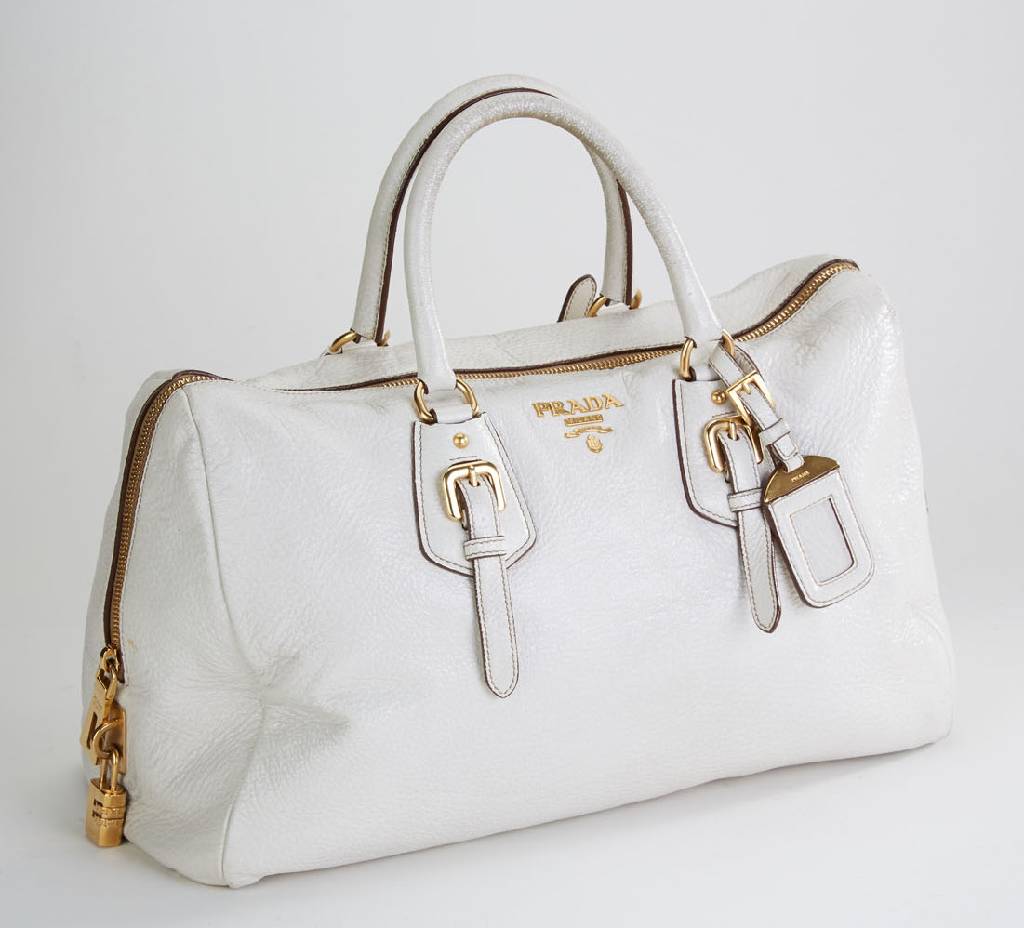 PRADA Handtasche, off-white Leder, 2 Tragehenkel, Schnallenapplikation, mit Zahlenschloss, innen champagnerfarb. Stoff mitPrada Stickerei, ca. 40 x ...
