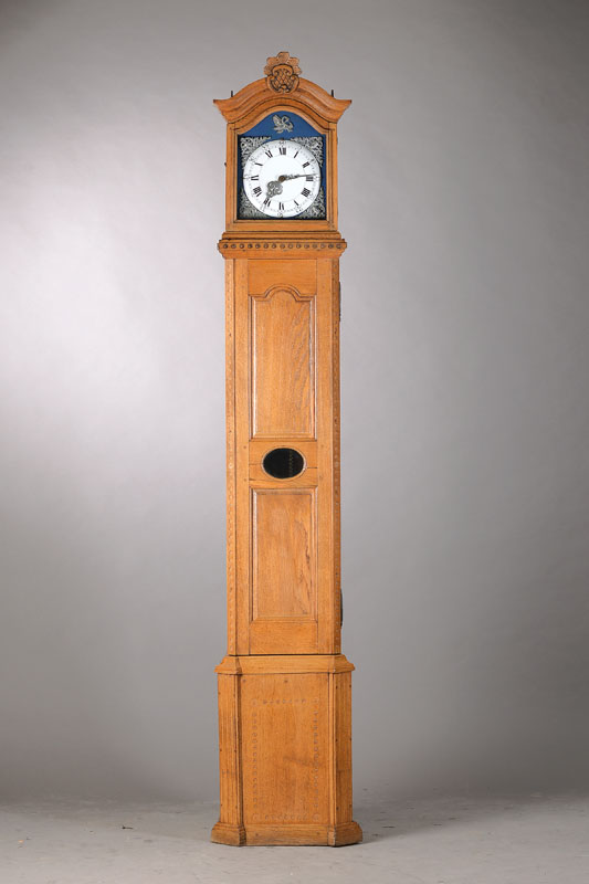 Standuhr, Westfalen um 1820/30, Eiche, aufgesetzter sog. Uhrenkopf, Schnitzarbeiten, Füsse u. 2 Verzierungen oben fehlen, Fayencezifferblatt, ...