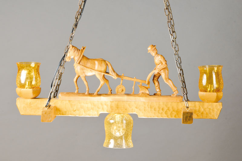 Deckenlampe, deutsch, Mitte 20. Jh., Lindenholz geschnitzt mit vollplastischer Figur: Bauer mit Pferd und Pflug, drei Brennstellen mit gelben ...