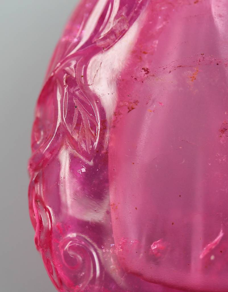 Detail d: Parfumflakon, Snuffbottle, China um 1890/1900, Flakon aus Rubellit, seitl. jeweils grav., Rocaillen- und Blätterdekor, ohne Stöpsel, ca. 4.5 x 5 cm