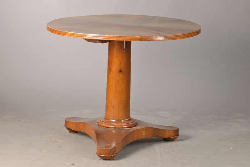 Runder Tisch, mitteldeutsch, um 1820, Nussbaum / Wurzelnussfurnier radial verlegt, Sockelplatte lt. gewölbt, strenger gerader Schaft, Plattenkante ...
