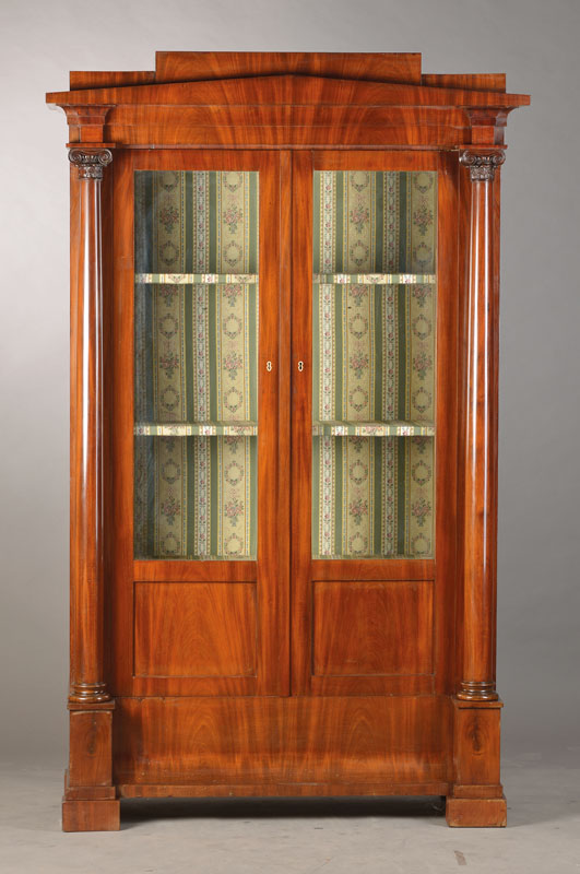 Säulenvitrine, wohl Berlin, um 1840, Pyramidenmahagonifurnier auf Weichholzkorpus, 2-türig, architektonischer Aufbau, Vollsäulen mit fein ...