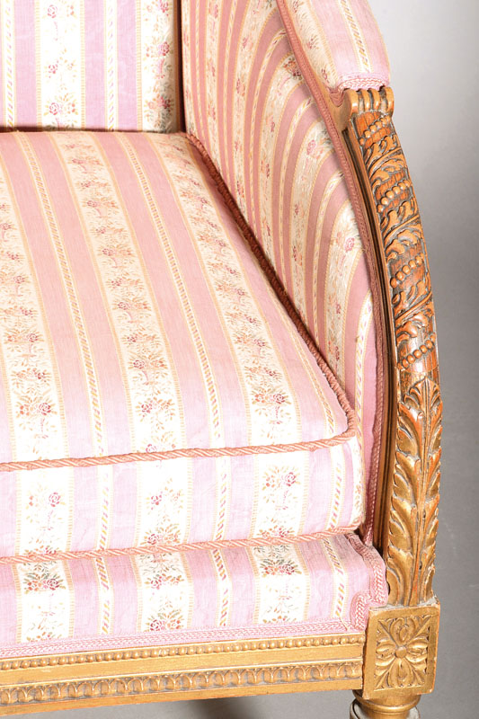 Detail a: Ohrenbackensessel, deutsch, um 1900, im Louis-XVI-Stil, umlaufend ornamental geschnitzt, konische kannelierte Beine, Reste alter Goldfassung, Polster ...