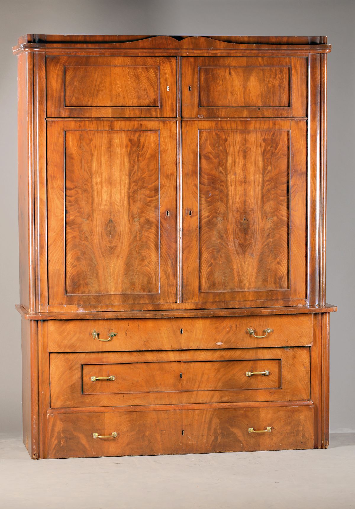 Aufsatzschrank, wohl Norddeutsch, um 1850, Mahagonifurnier, Unterteil 3-schübig, Aufsatz 4-türig, Giebel mit regionstypischem symmetrischem ...