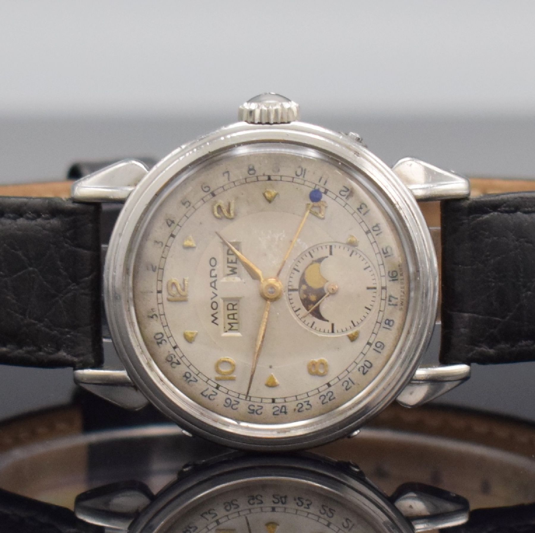 Detail a: MOVADO Herrenarmbanduhr mit Kalender, Schweiz 1940er Jahre, Edelstahlgehäuse mit tropfenförm. Bandanstößen, Boden geschr., Korrekturdr. seitl. im ...